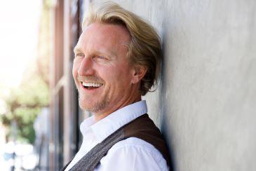 man smiling after seeing the cosmetic dentist in mccrae