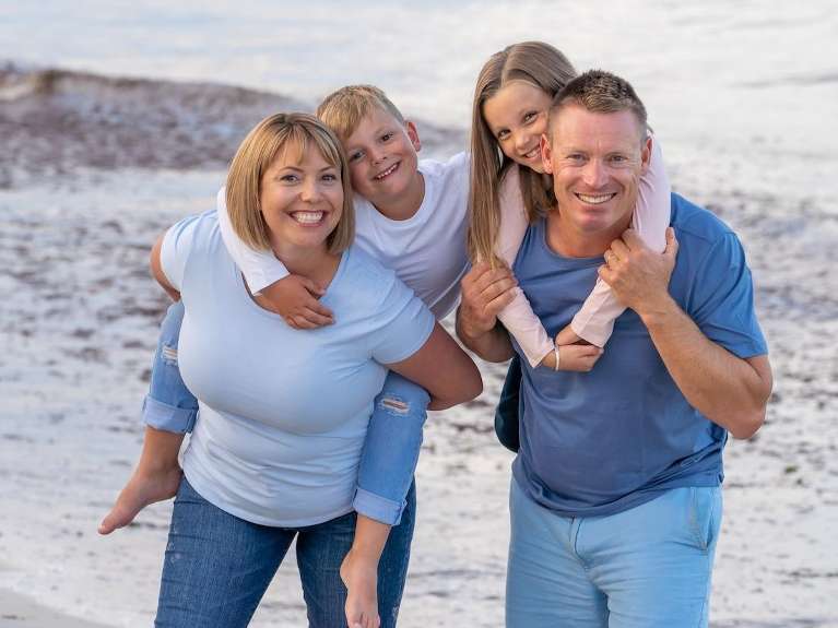family at the beach after finding a dentist near you in McCrae