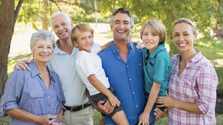 Family smiling for photo in Rosebud, VIC, near Bays Dental Clinic