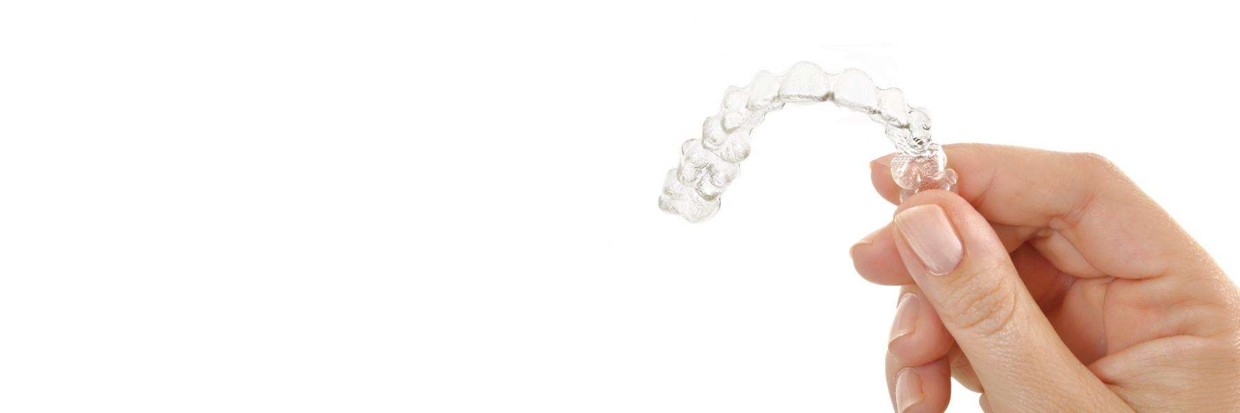 clear aligners mccrae | person holding clear aligner